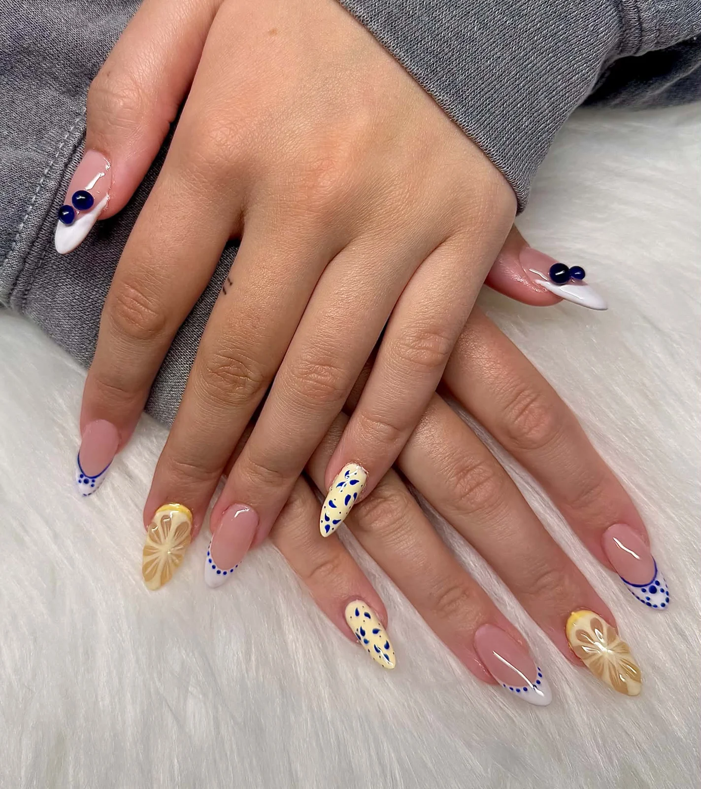 Lemon nail art and blue dotted French tips on Gel X nails in Thompson
